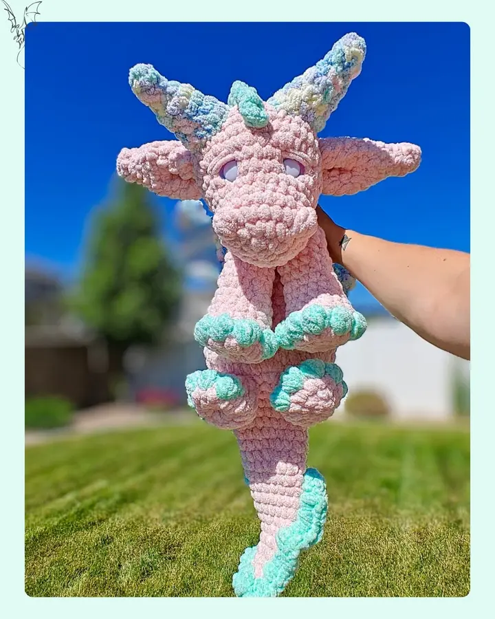 A cute, cuddly crocheted Cato the Dragon snuggle buddy