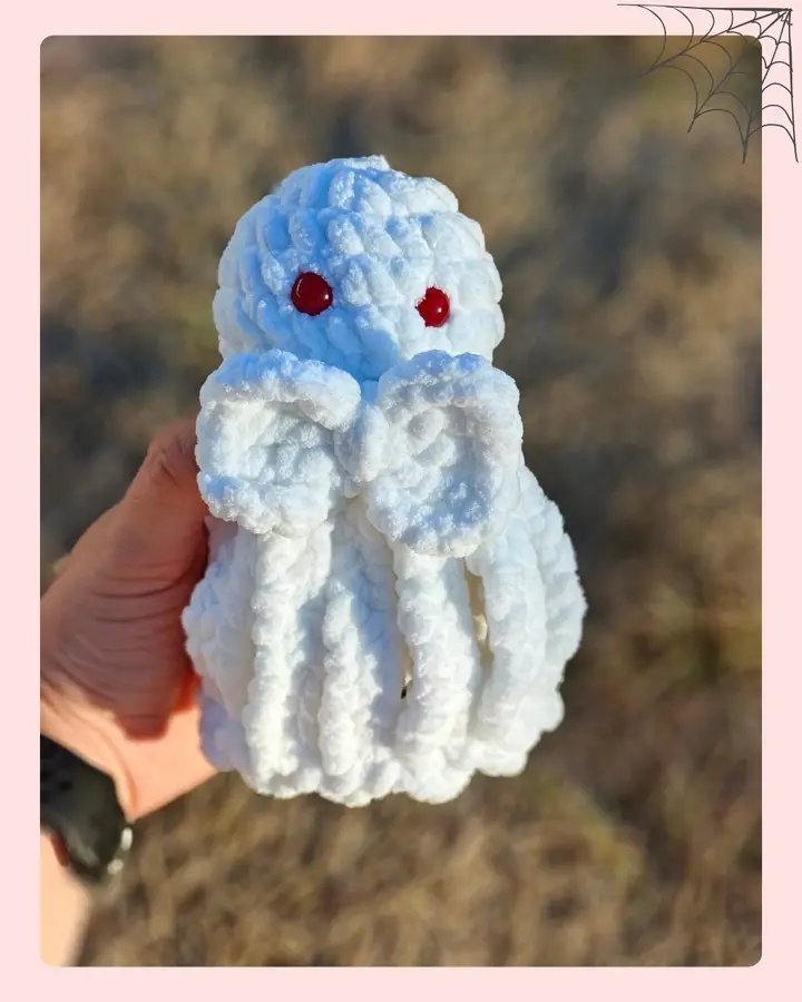 A cute crocheted ghost lovey with a little bow, perfect for Halloween
