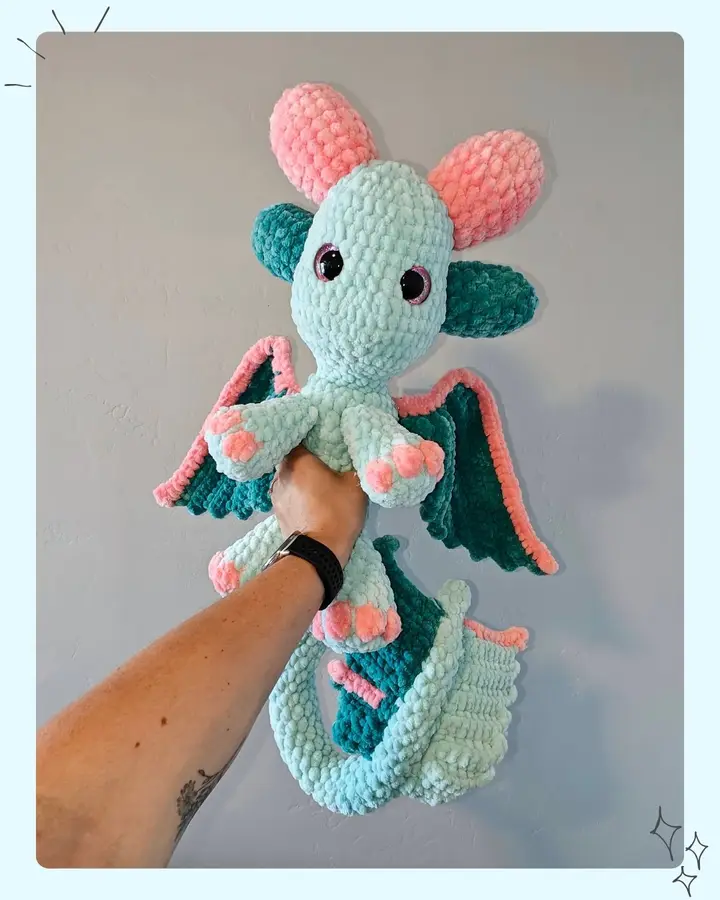 Joy the Dragon, a crocheted dragon with angel wings that wrap around the body