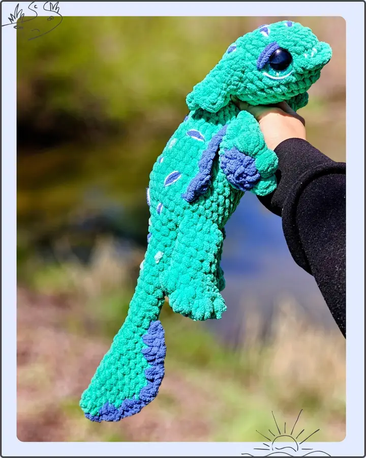 Puddlewick the River Guardian, a crocheted creature in river greens and browns