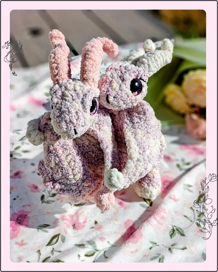 Skye the Pauper Dragon, a small crocheted dragon in soft blue and cream tones