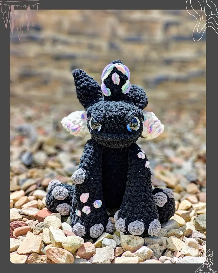 Vexley the Voidscale, a crocheted dragon with an iridescent look from blended blanket yarn shades
