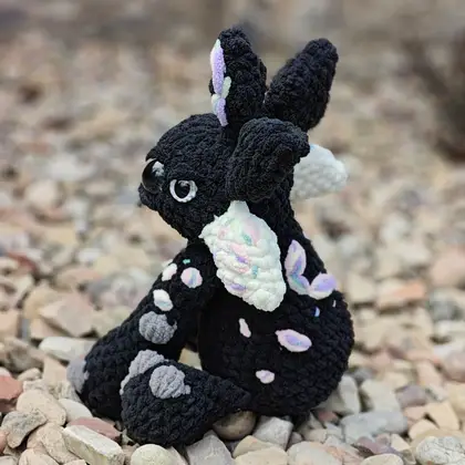Vexley the Voidscale seated, tail curled around the base